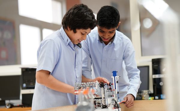 Students working on a robotic model at the Robotics Lab at Abu Dhabi International School
