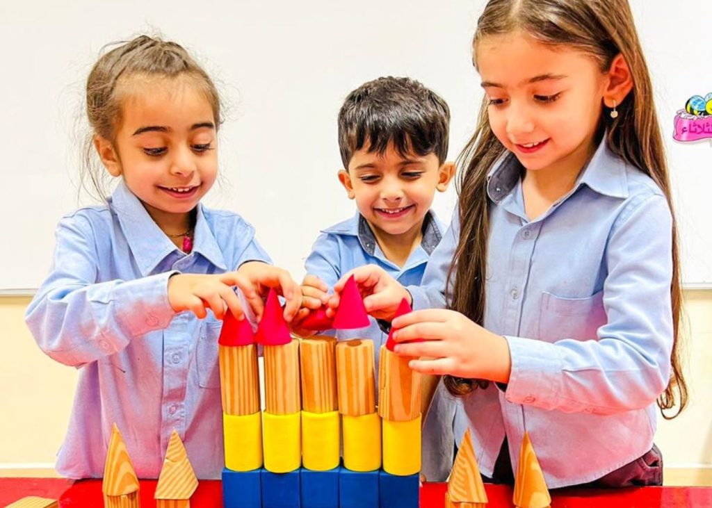 Elementary students learning with blocks at Abu Dhabi International School